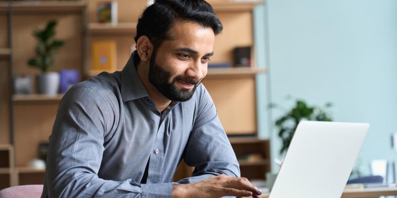 man browsing on laptop